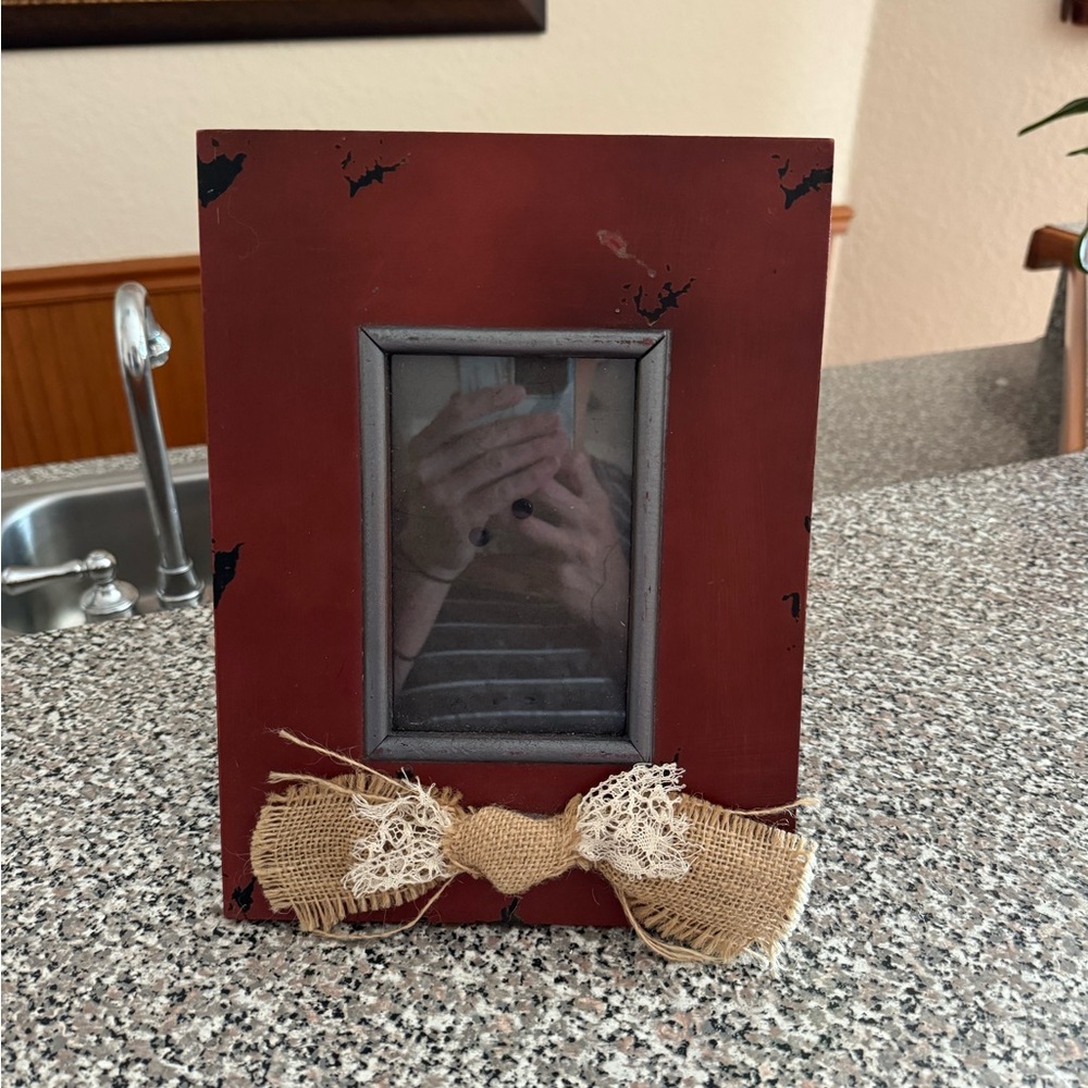 Rustic wood picture frame with burlap bow centered across the bottom